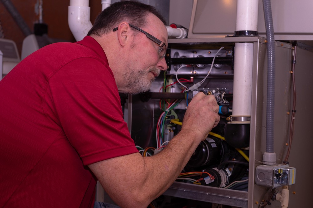 technician inspecting furnace