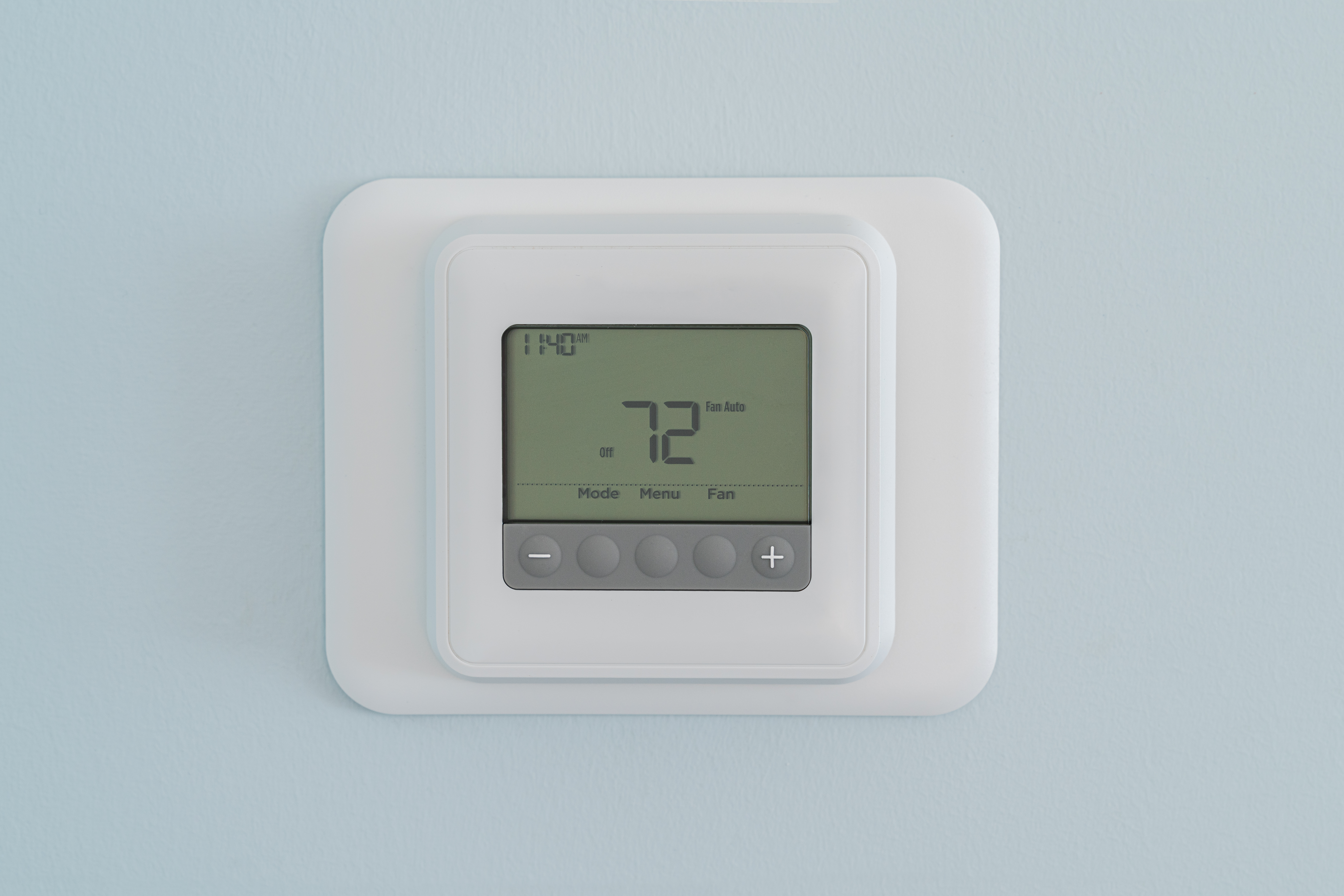 A digital thermostat mounted on a light blue wall displays the ideal thermostat temperature of 72 degrees Fahrenheit along with the current time. | C & C Heating & Air Conditioning